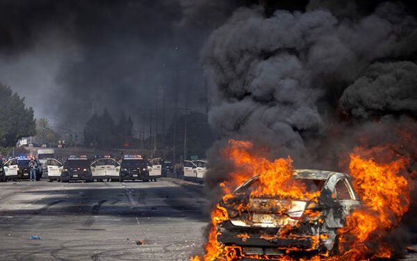 Masked protesters Los Angeles wildfires smoke air quality demonstration climate